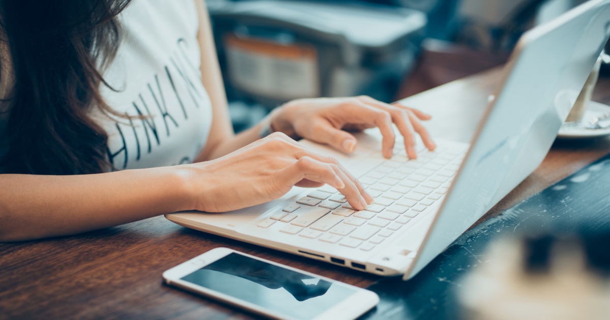 person working on white laptop